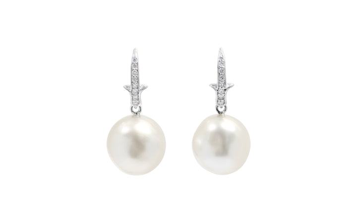 A pair of White South Sea pearl diamond  shepherd hook earrings in 18k white gold is displayed on a white background.