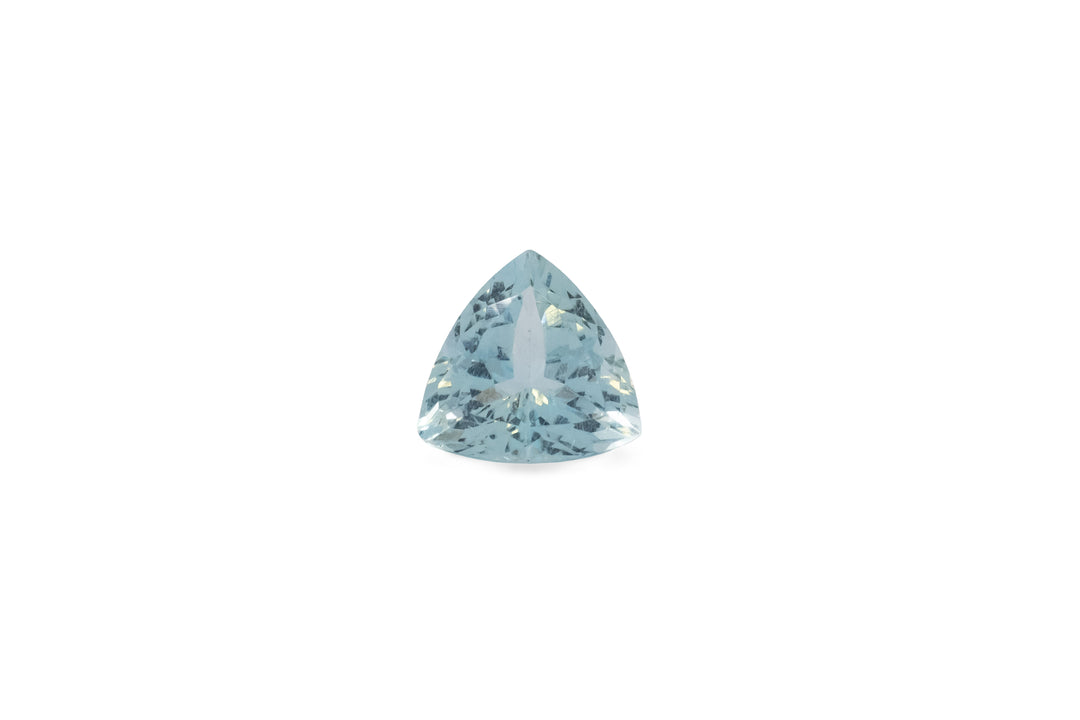 A trillion cut pale blue aquamarine gemstone is displayed on a white background.