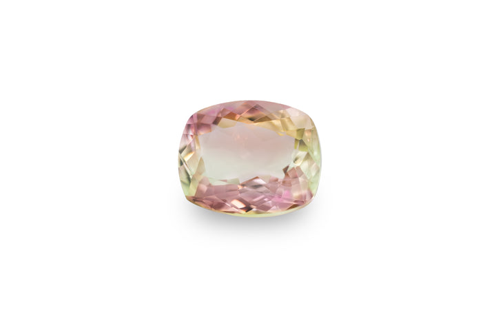 A cushion cut bi colour pink yellow tourmaline gemstone is displayed on a white background.