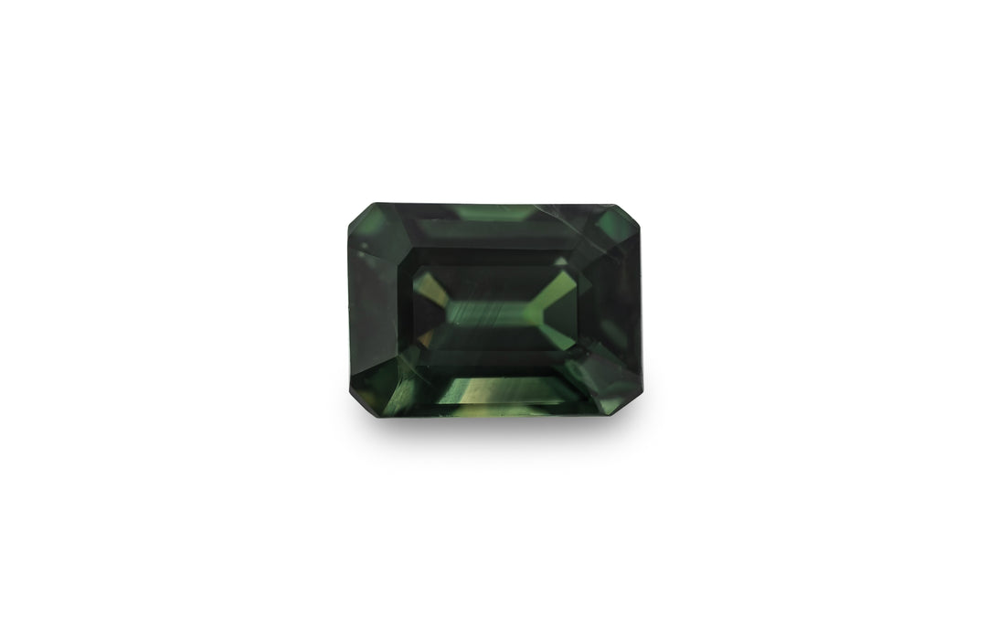 An emerald cut green Australian sapphire is displayed on a white background.