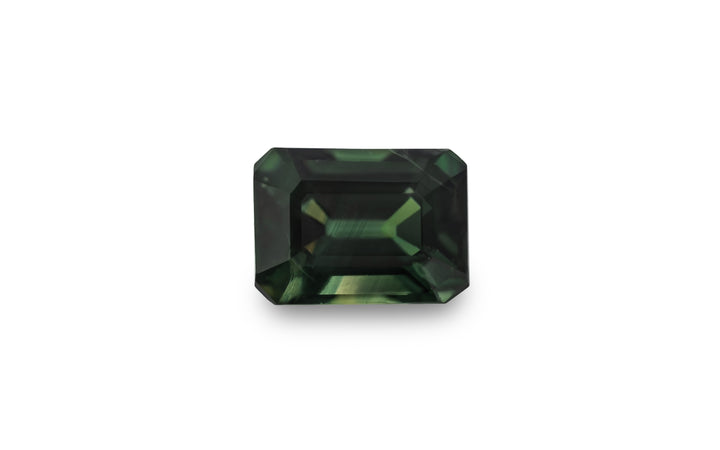 An emerald cut green Australian sapphire is displayed on a white background.