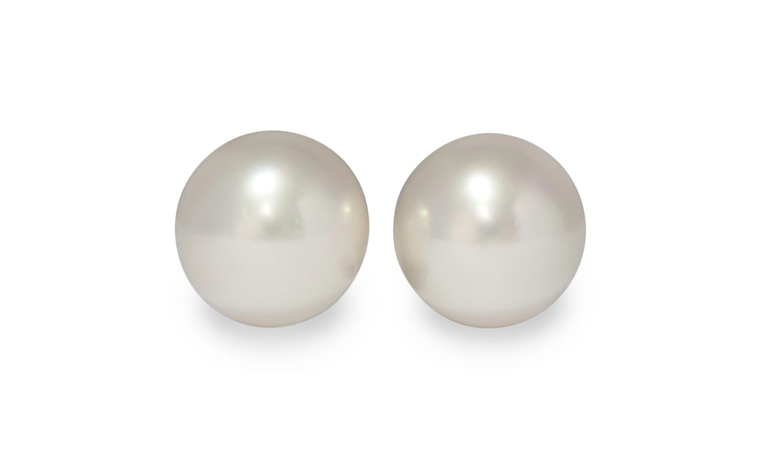 A pair of semi round pink/white south sea pearl pairs are displayed on a white background.