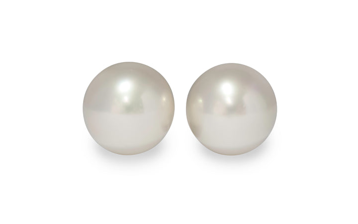 A pair of semi round pink/white south sea pearl pairs are displayed on a white background.
