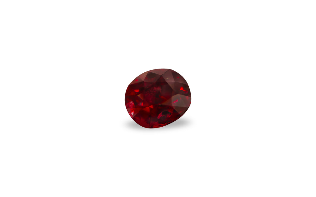 A cushion cut African ruby gemstone is displayed on a white background.
