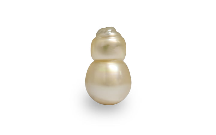 A baroque shape light gold Golden South Sea pearl is displayed on a white background.