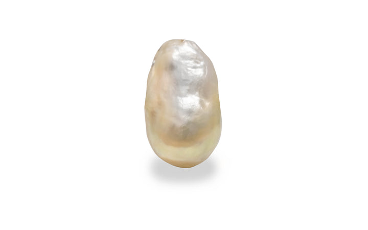 A baroque shape light gold South sea pearl is displayed on a white background.