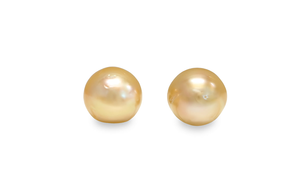 A button shape deep Golden South Sea pearl pair is displayed on a white background.