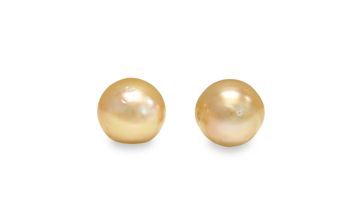 A button shape deep Golden South Sea pearl pair is displayed on a white background.