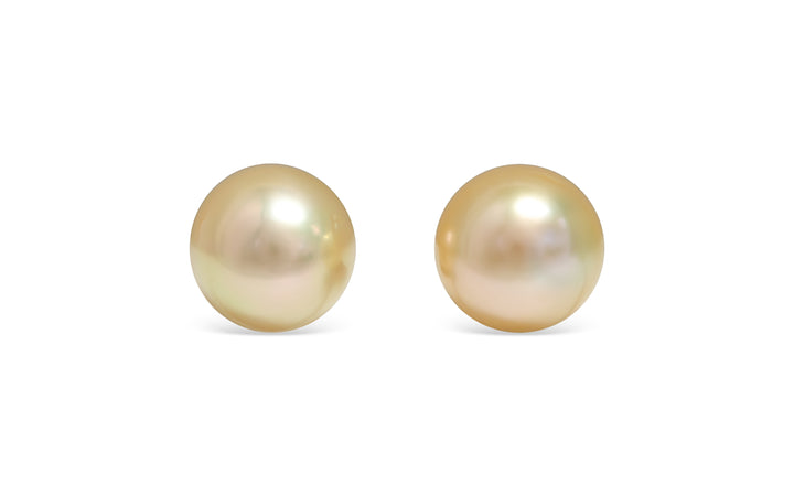 A button shape deep Golden South Sea pearl pair is displayed on a white background.
