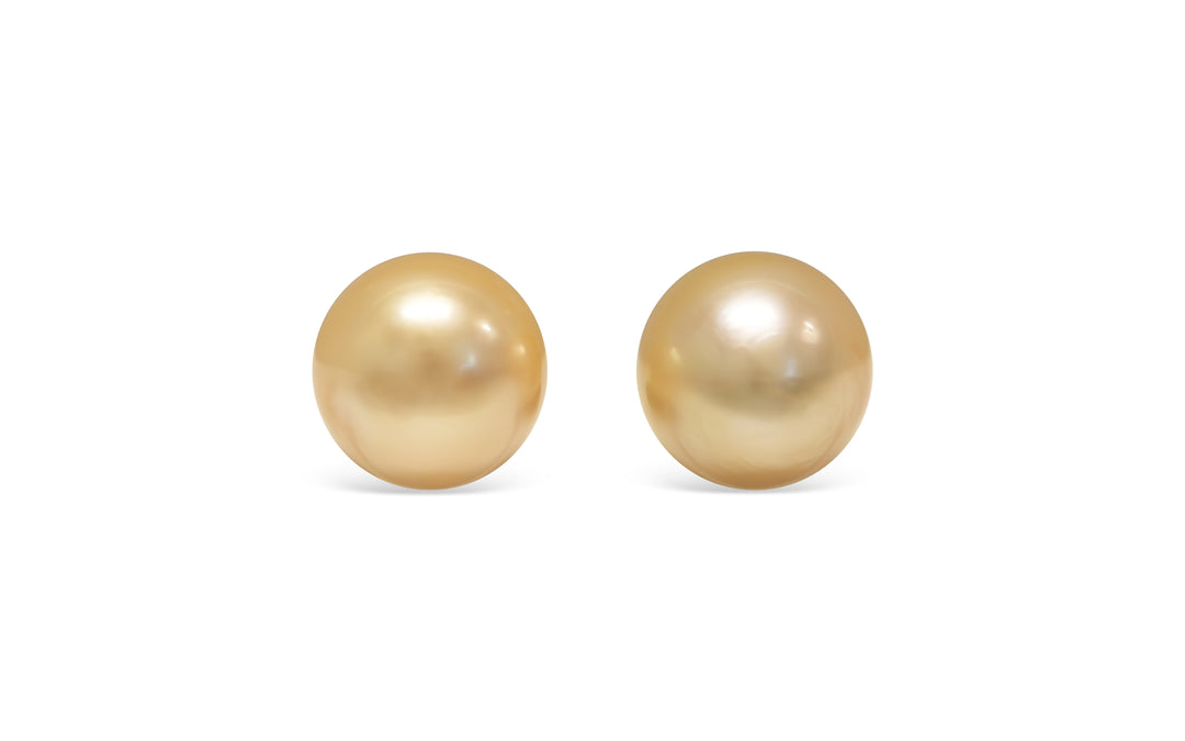 A button shape deep Golden South Sea pearl pair is displayed on a white background.