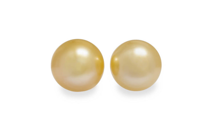 A button shape light gold Golden South Sea pearl pair is displayed on a white background.