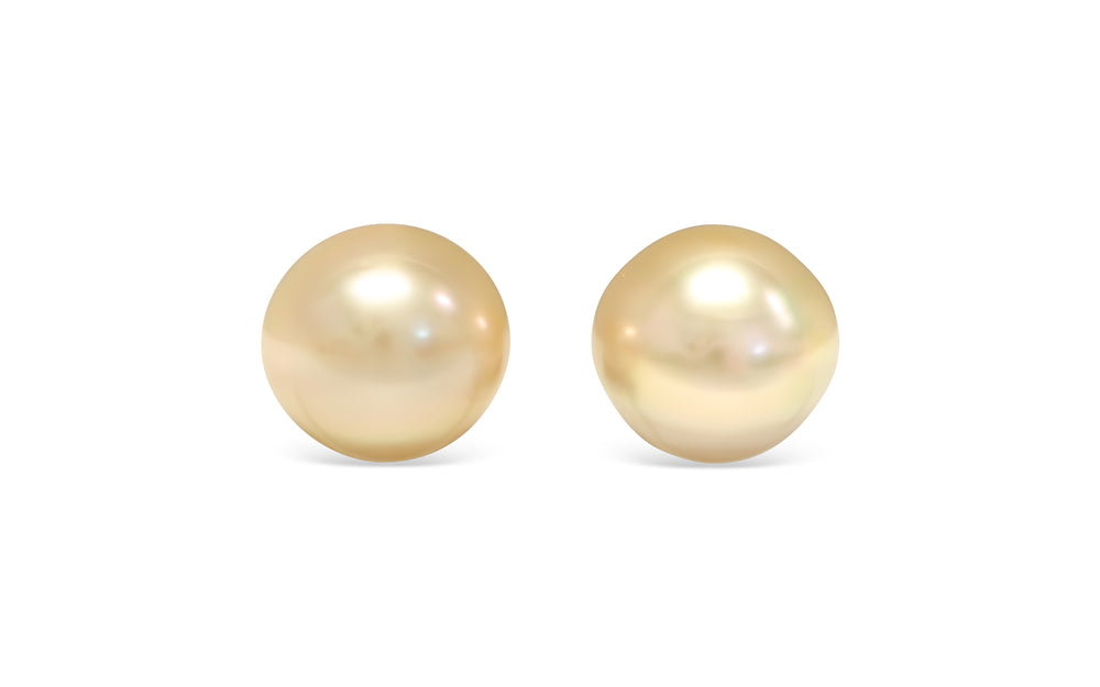 A button shape light Golden South Sea pearl pair is displayed on a white background.