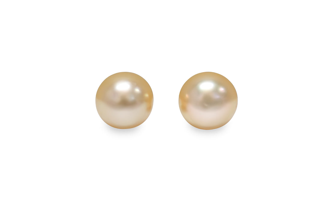 A button shape light Golden South Sea pearl pair is displayed on a white background.