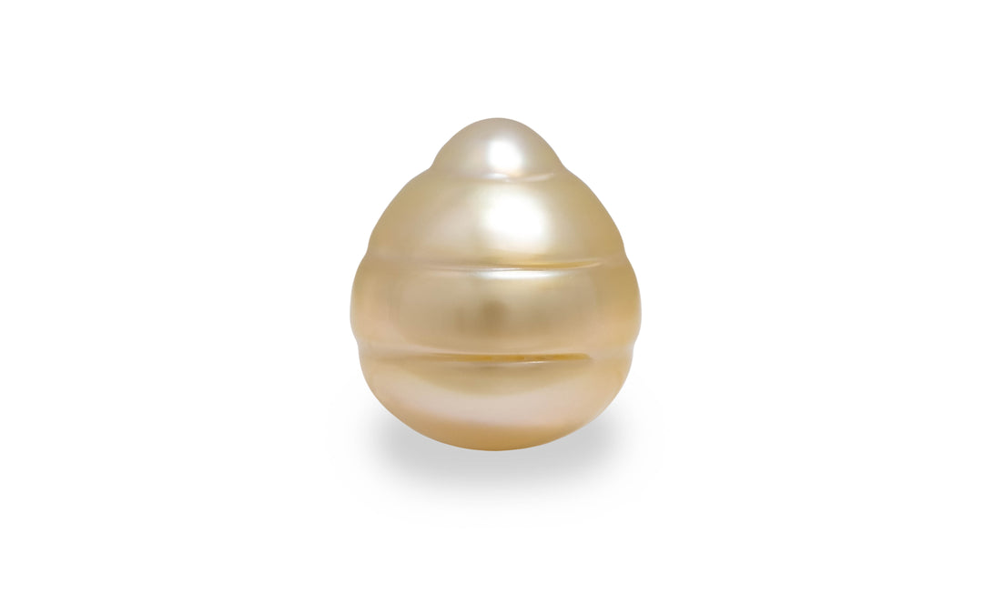 A circle shape light gold South sea pearl is displayed on a white background.