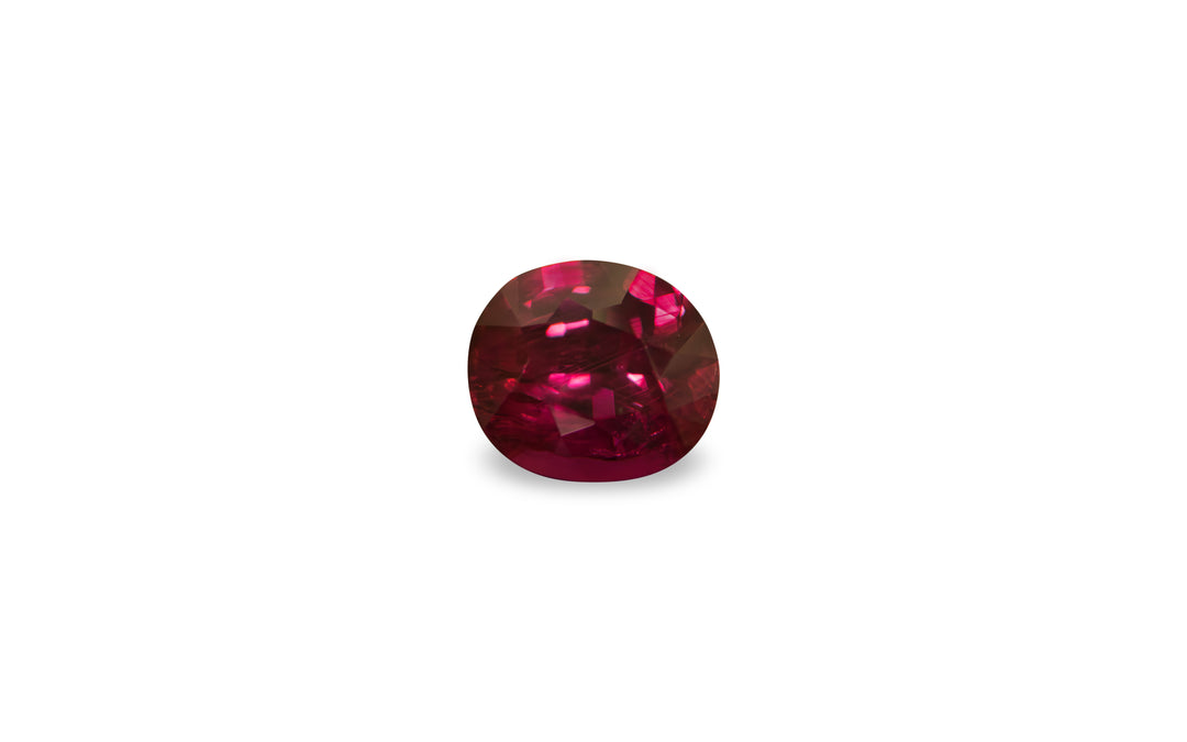 A cushion cut African ruby gemstone is displayed on a white background.