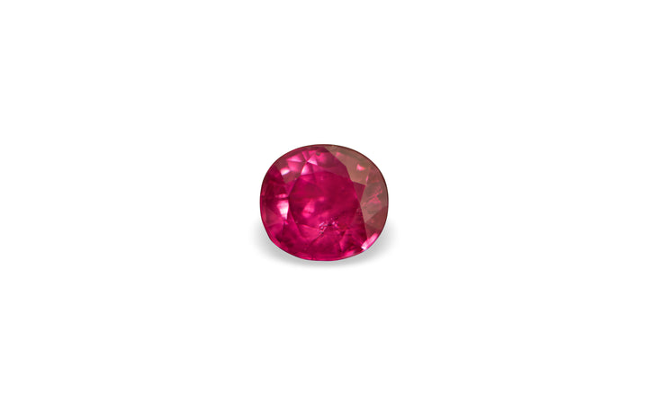 A cushion cut Burmese ruby gemstone is displayed on a white background.