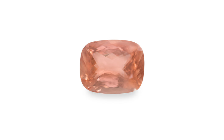 A cushion cut peach morganite gemstone is displayed on a white background.