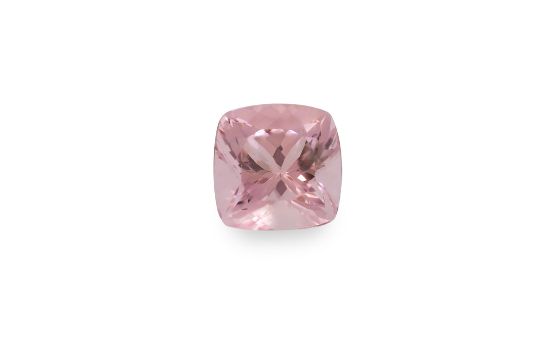 A cushion cut pink morganite gemstone is displayed on a white background.