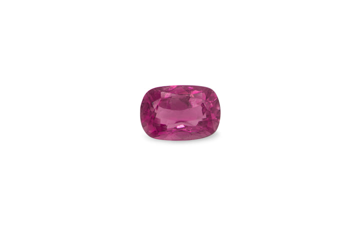 A cushion cut pink Ceylon sapphire gemstone is displayed on a white background.