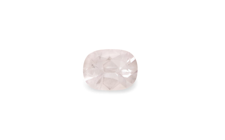 A cushion cut white Ceylon sapphire gemstone is displayed on a white background.