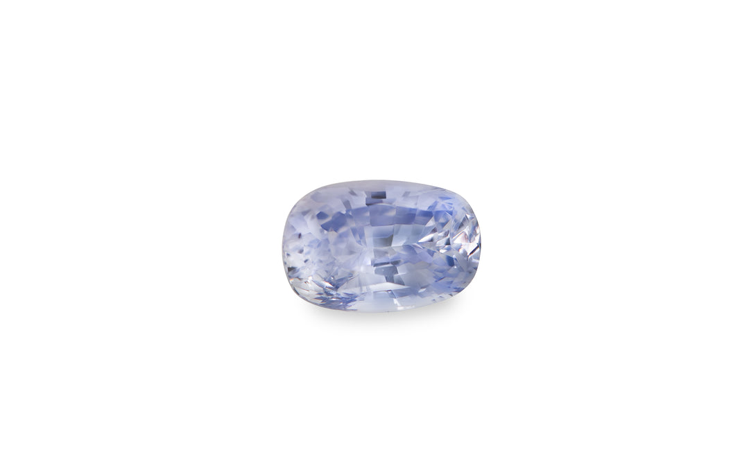 A cushion cut purple Burmese sapphire gemstone is displayed on a white background.