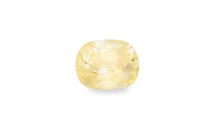 A cushion cut yellow sapphire gemstone is displayed on a white background.