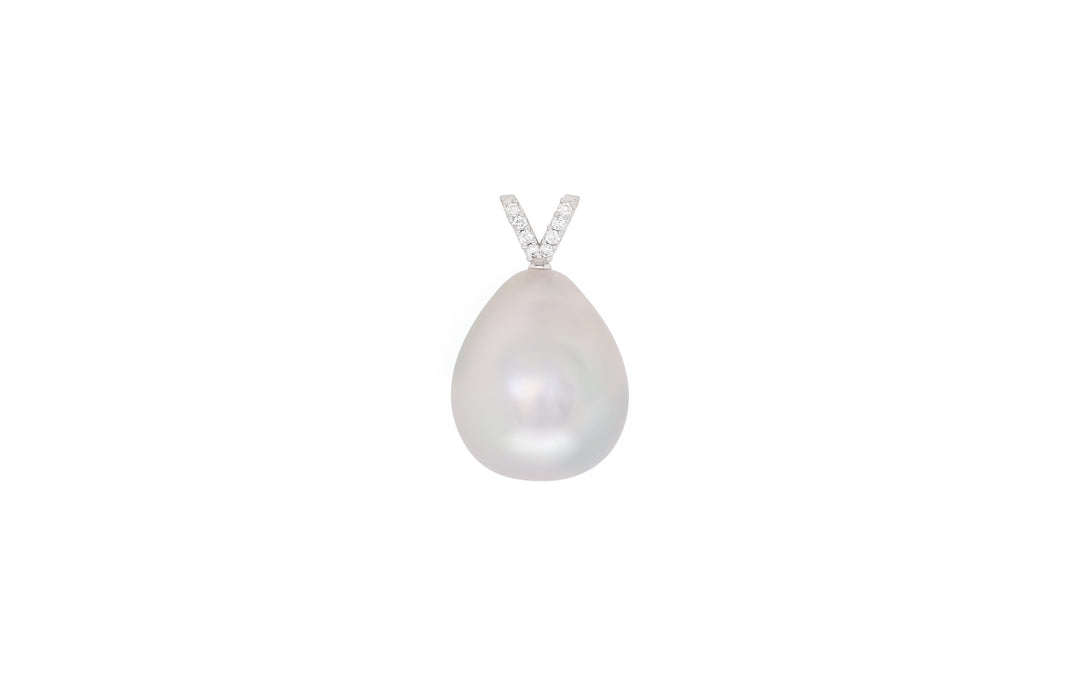 A drop shaped white South Sea pearl pendant with diamonds in 18k white gold is displayed on a white background. 