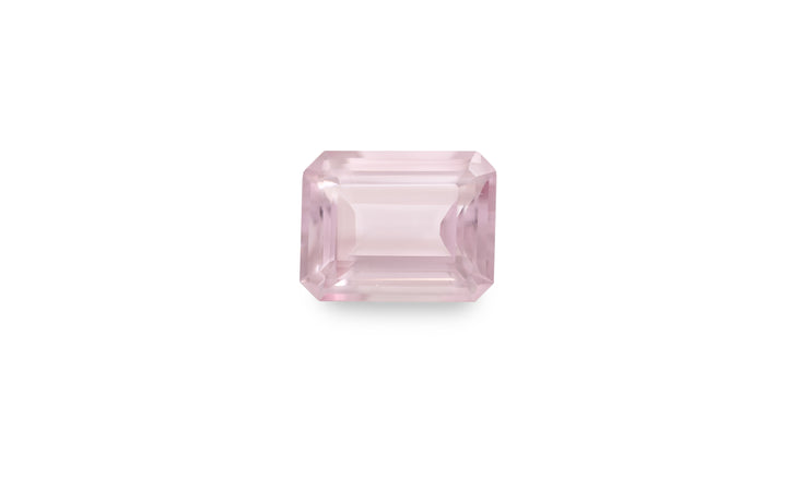 An emerald cut pink morganite gemstone is displayed on a white background.