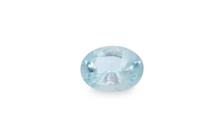 An oval cut aquamarine gemstone is displayed on a white background.