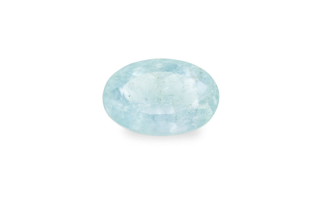 An oval cut aquamarine is displayed on a white background. 
