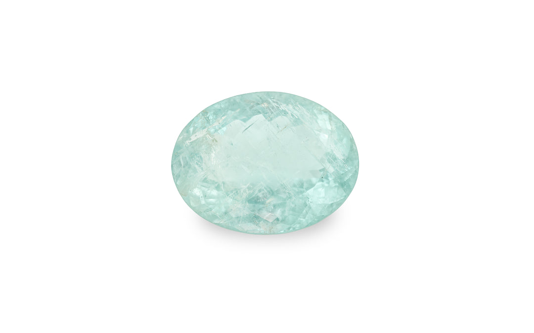 An oval cut aquamarine gemstone is displayed on a white background.
