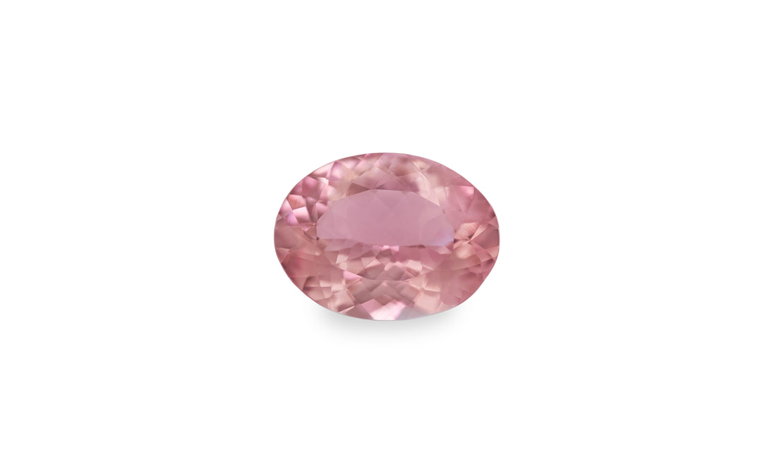 An oval cut pink morganite gemstone is displayed on a white background.