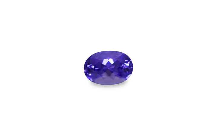 An oval cut purple blue Tanzanite gemstone is displayed on a white background.