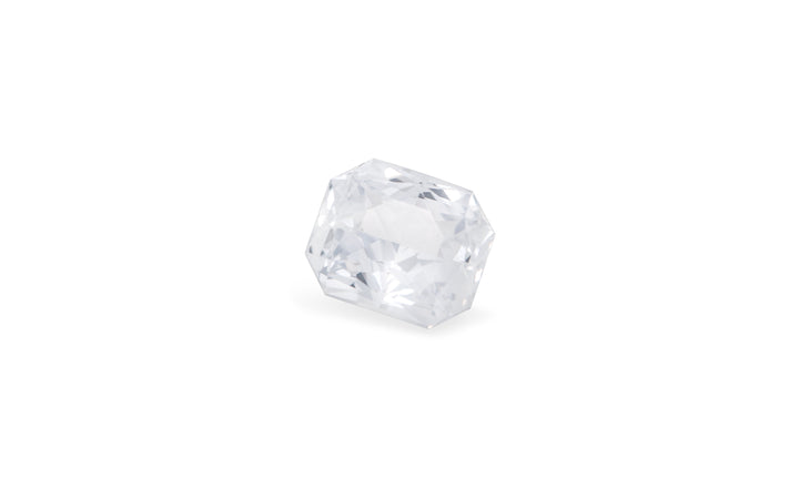 A radiant cut white Ceylon sapphire gemstone is displayed on a white background.