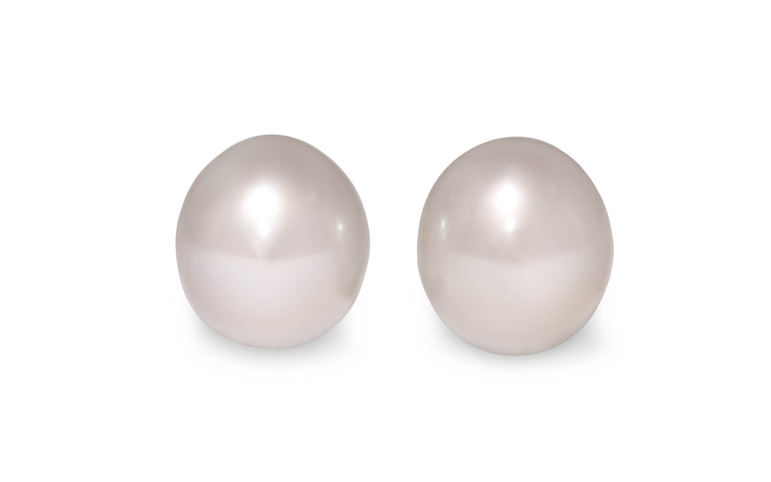 An oval shape pink white South Sea pearl pair is displayed on a white background.