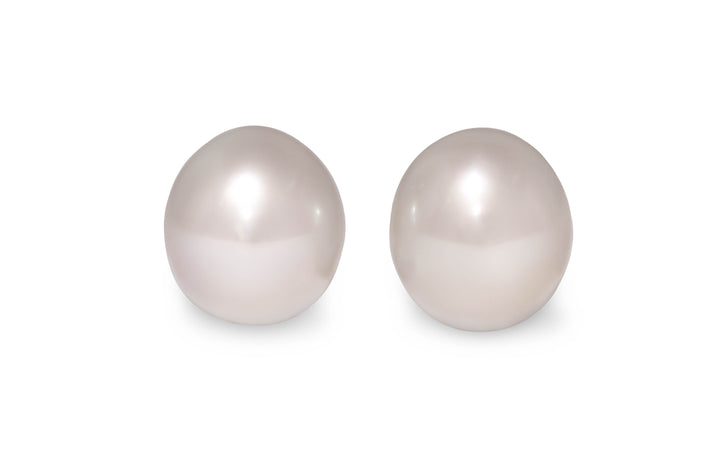 An oval shape pink white South Sea pearl pair is displayed on a white background.