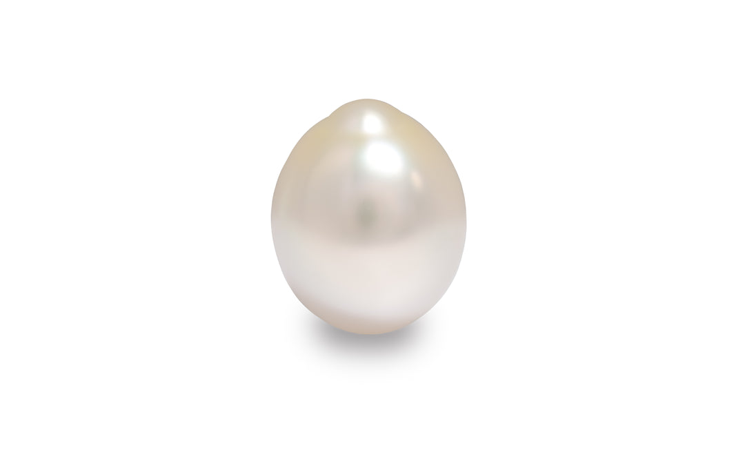 An oval shaped white gold golden South Sea pearl is displayed on a white background.