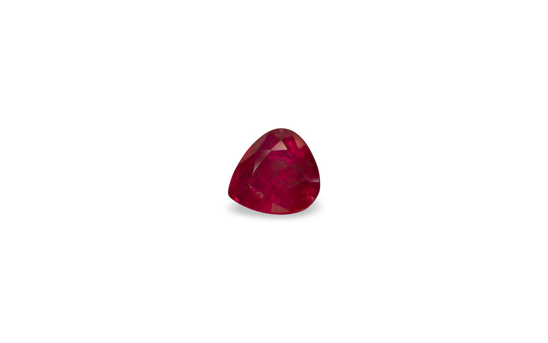 A pear cut Burmese ruby gemstone is displayed on a white background.