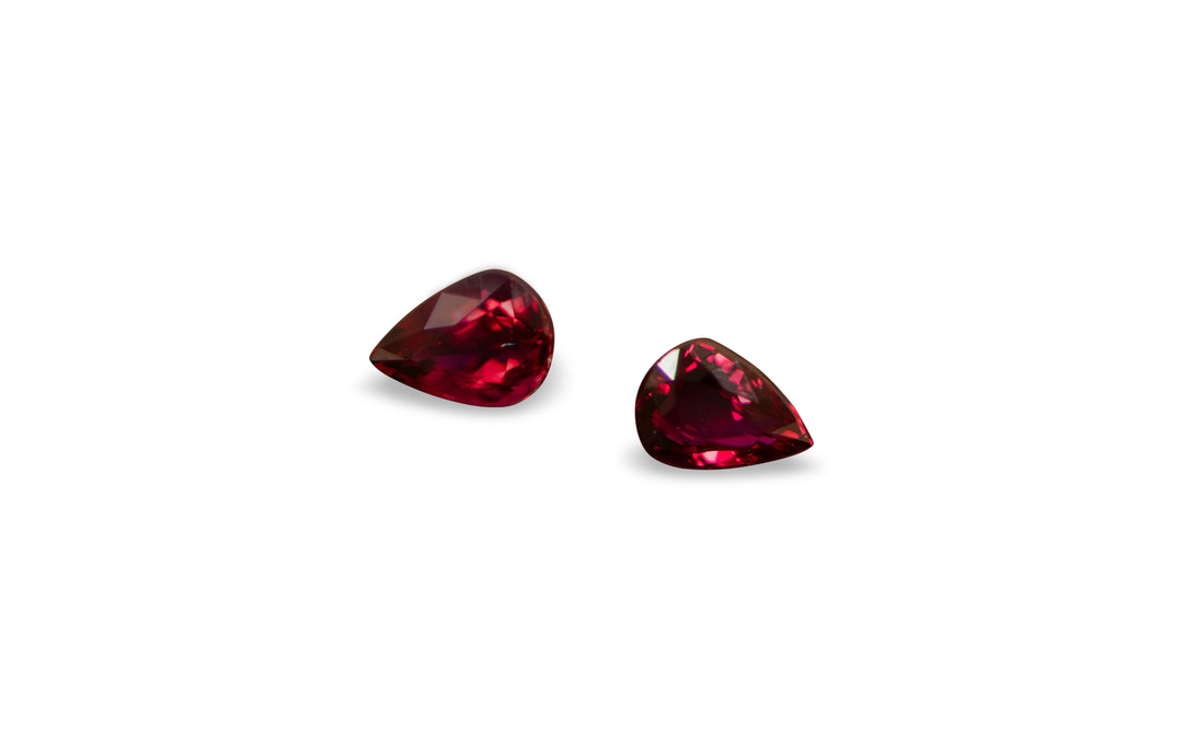 A set of pear cut African ruby gemstones is displayed on a white background.