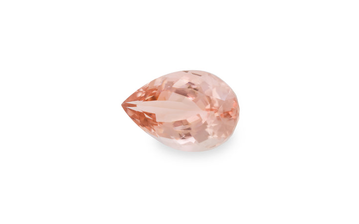 A pear cut peach morganite gemstone is displayed on a white background.