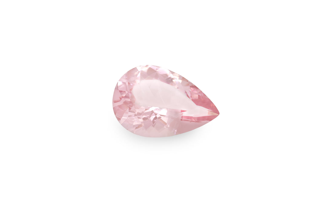 A pear cut pink morganite gemstone is displayed on a white background.