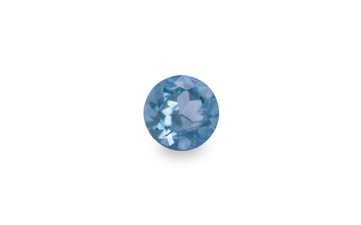 A round brilliant cut aquamarine gemstone is displayed on a white background.