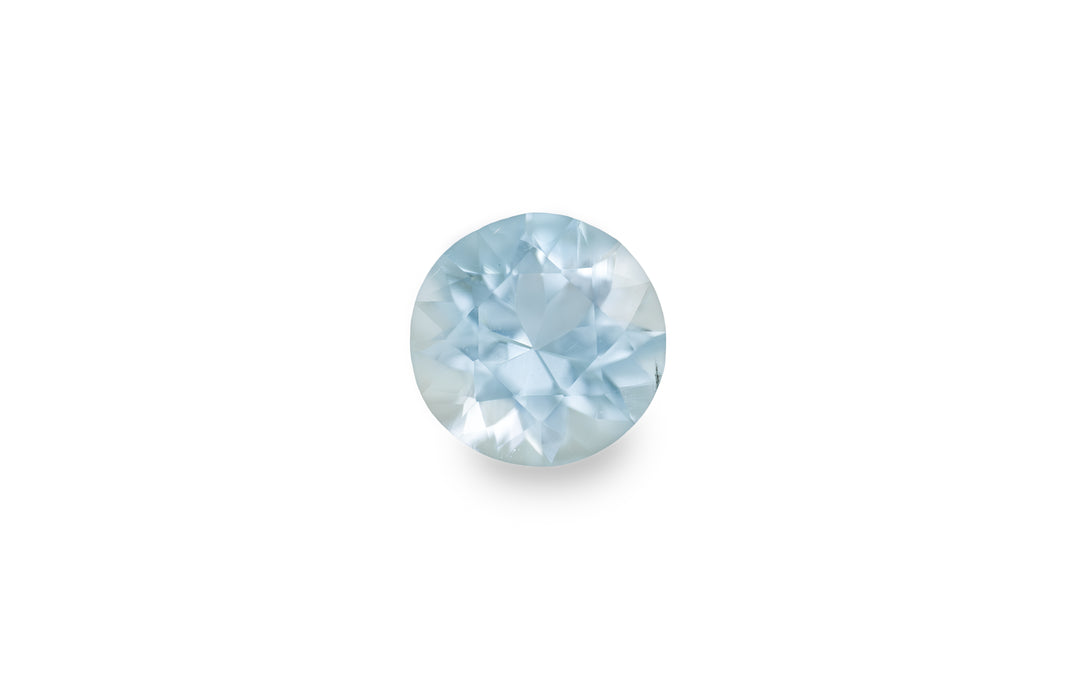 A round brilliant cut aquamarine gemstone is displayed on a white background.