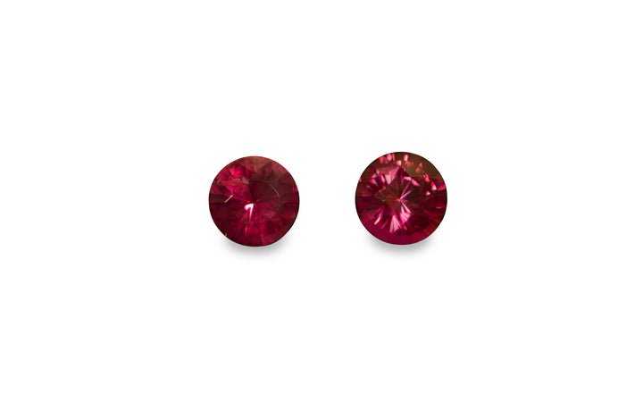 A set of round brilliant cut African ruby gemstones is displayed on a white background.