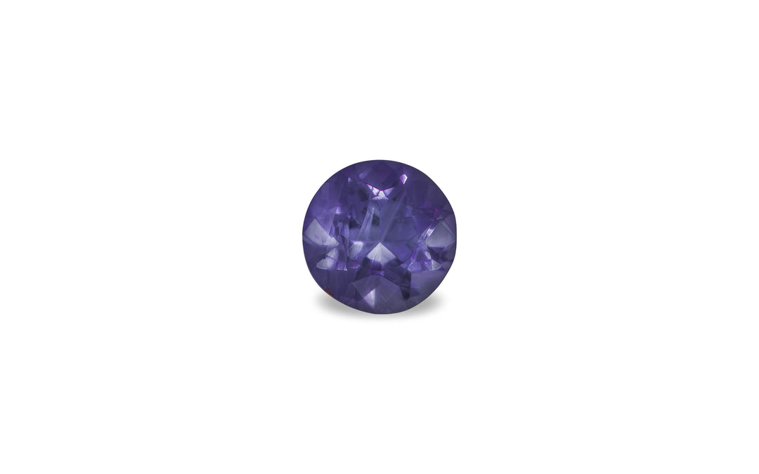 A cushion cut purple Burmese sapphire gemstone is displayed on a white background.