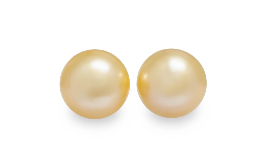 A round shape light gold Golden South Sea pearl pair is displayed on a white background.
