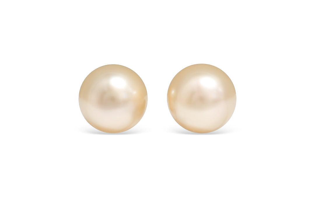 A round shape light Golden South Sea pearl pair is displayed on a white background.