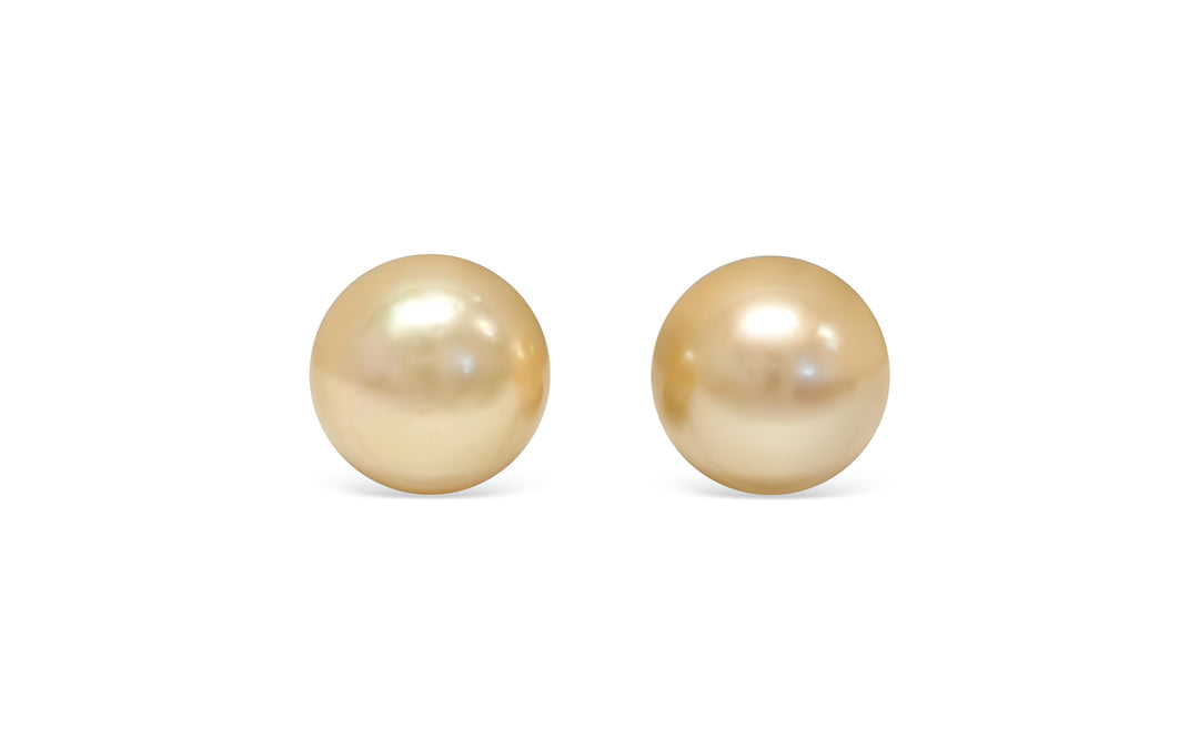 A round shape light Golden South Sea pearl pair is displayed on a white background.