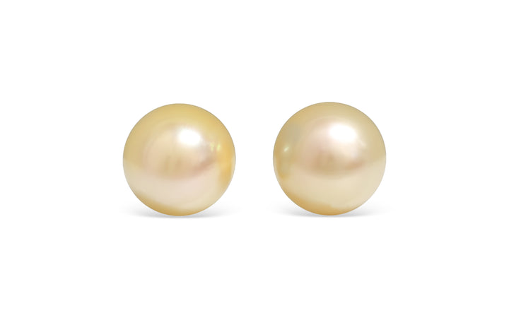 A round shape light Golden South Sea pearl pair is displayed on a white background.