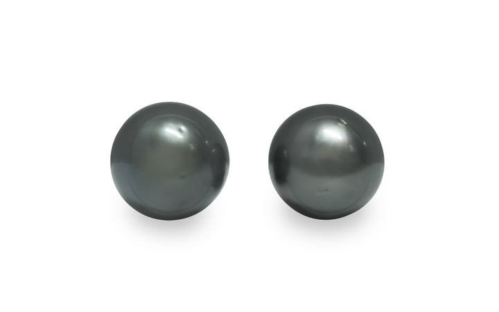 A round shape Tahitian pearl pair is displayed on a white background.